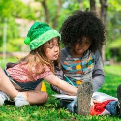 Aws Boy And Girl Student Sitting In Grass Doing Homework