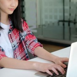 Aws Girl In Plaid Shirt Typing On Laptop