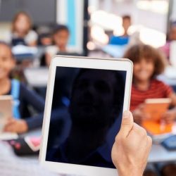 Aws Teacher Holding Tablet In Front Of Class